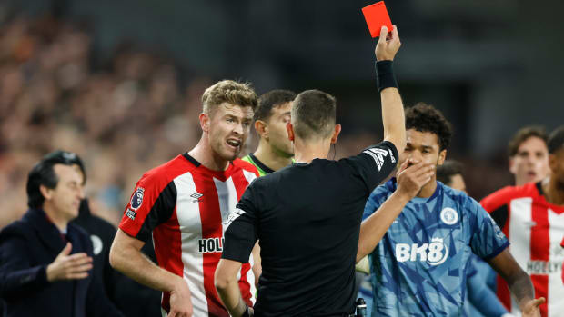 Referee David Coote pictured showing a red card to Boubacar Kamara (right) towards the end of Aston Villa's 2-1 win at Brentford in December 2023